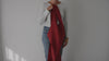 woman showing how to wear the cross back prairie smock apron in red linen by portland apron company